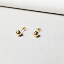 Charger l'image dans la galerie, Petites puces d’oreilles boule en or massif 18 carats 750 en or jaune poli, présentées sur support métal.